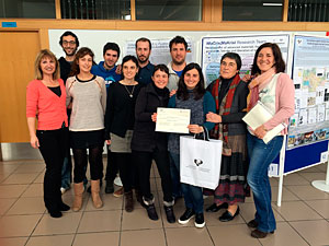 Reseach team posing next to the poster